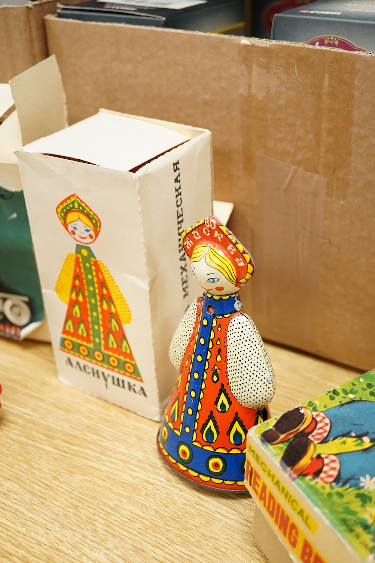Three boxed clockwork tinplate toys - a 1960s Japanese Cubby the Reading Bear, by Alps (Japan), 17cm high, a USSR doll, and a later ‘Roli Zoli’ clown on a scooter (3)